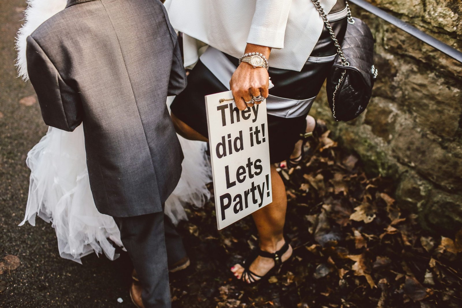 woman standing with boy while holding white signage